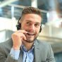 Smiling friendly handsome young male call centre operator